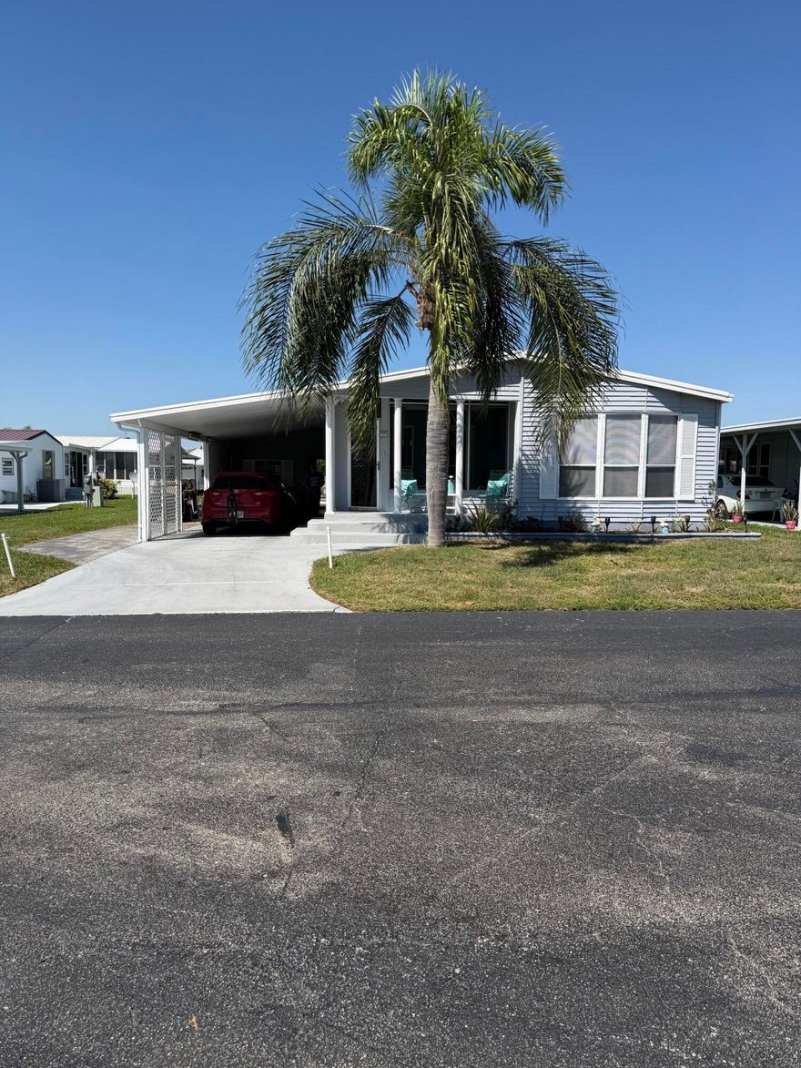 Welcome to Oasis Village- A 55+ Community. This beautifully maintained 2 Bedroom 2 Bath, furnished home is comfort ready! Spacious master suite with walk-in closet. Large outside utility room for extra storage. Covered carport for parking. Relax and enjoy the water right out your back door is a million dollar view!  Nice work shop and covered patio. Perfect for year-round living or a seasonal retreat, this home has everything you need to enjoy the Florida lifestyle. 2 screened-in porches front and rear. Community amenities include a  clubhouse, heated pool for year-round relaxation. Covered mailboxes for added convenience. Located minutes from public boat ramps, close to shopping, and only 30 minutes from Brighton Bay Casino, you'll enjoy the best of both relaxation and recreation.