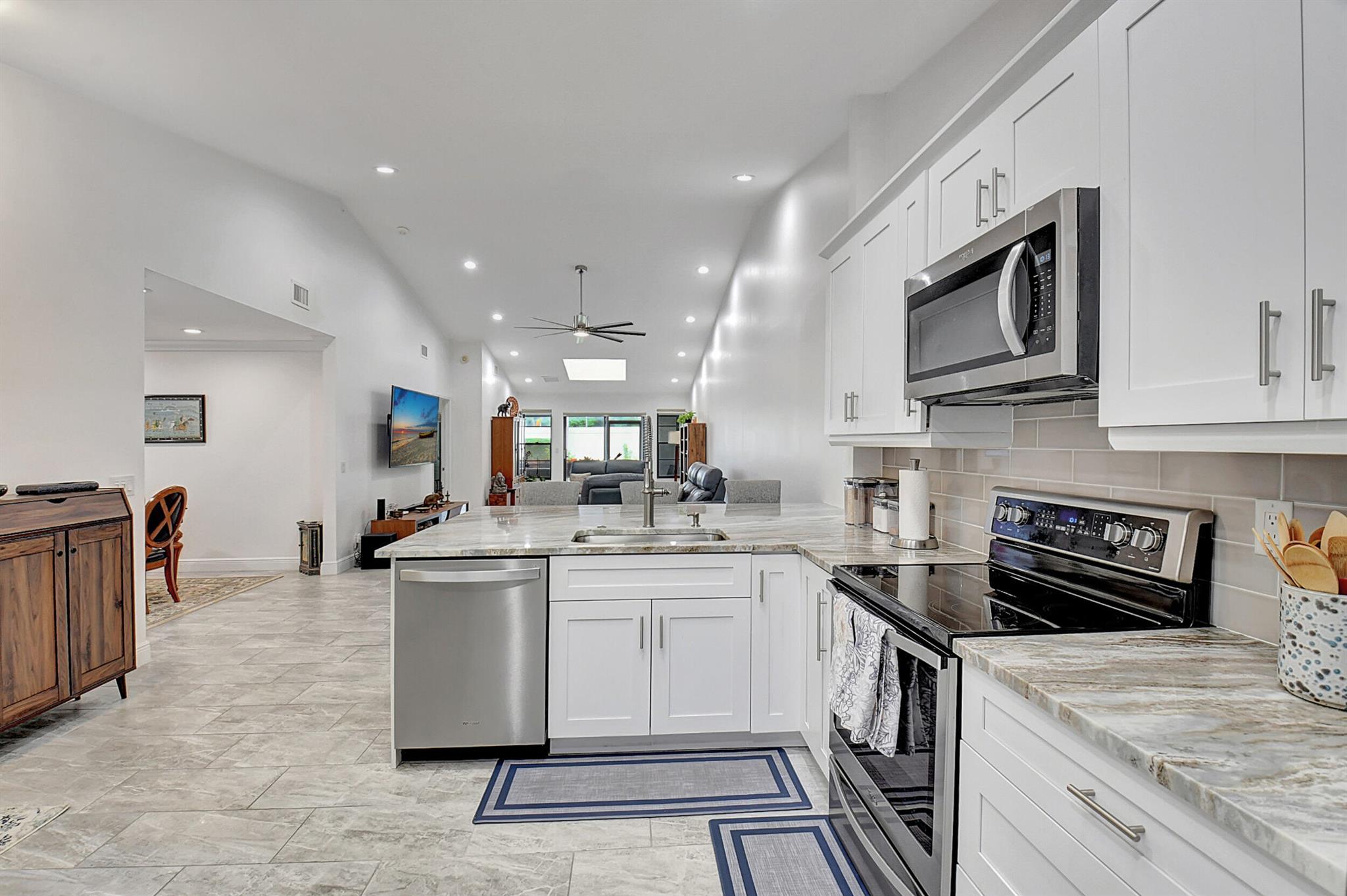 Bring your toothbrush! MOVE IN READY!No MEMBERSHIP FEES!Delightfully remodeled VILLA (2019) in the well sought out neighborhood of Palm Chase Lakes; Upgrades include New 15'' X 30'' Himalayan Quartz Porcelain Tile Throughout (no carpet anywhere), Smooth ceilings in all main areas, Both bathrooms are fully redone, with a Rain-Head sized shower fixture and double vanity in the en-suite. Freshly painted with new doors, base, crown molding and hardware throughout. Home is also outfitted with accordion shutters for all window and door openings.The last surprise of this home is an additional conditioned patio that can be used for exercise or entertainment!You'll appreciate how well this home was maintained and it shows - Schedule your private showing before to see it for yourself.
