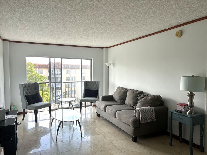 Beautiful top floor 2/2 condo is located in a well-maintained gated community. This apartment features stainless steel appliances, laminate flooring, built-in closets and renovated bathrooms. Stacked washer and dryer inside the unit. Unit has a fully screened in balcony and storm impact windows.