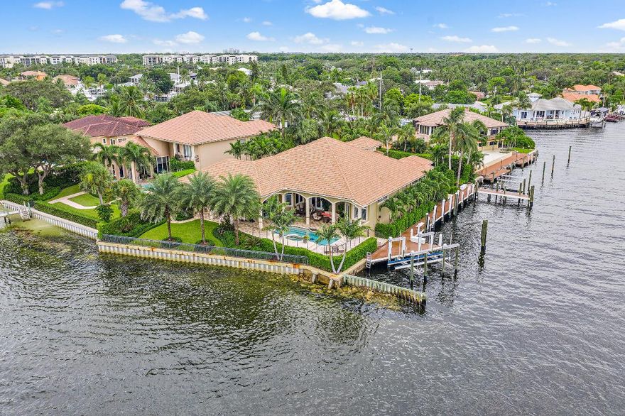 With a cul-de-sac location and gated entrance this stunning Intracoastal estate on a point lot has 270' of water frontage, East exposure and views of a nature preserve. The 145' deepwater dock will handle large vessels up to approximately 90', has water, 220/110 amp service and two boat lifts. The custom kitchen offers a breakfast bar, center-island and a large walk-in pantry. Other features include a custom built-in wet bar with wine cooler and refrigerator, gas fire place, large office with built-in's, his and hers baths in the master with exercise room and California closeting, full impact windows, tank-less gas water heater and a 45 KW whole house generator with automatic transfer switch. A large media room could be used or converted into a 5th bedroom.
