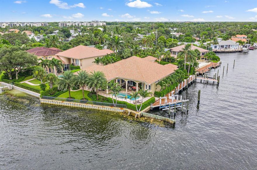With a cul-de-sac location and gated entrance this stunning Intracoastal estate on a point lot has 270' of water frontage, East exposure and views of a nature preserve. The 145' deepwater dock will handle large vessels up to approximately 90', has water, 220/110 amp service and two boat lifts. The custom kitchen offers a breakfast bar, center-island and a large walk-in pantry. Other features include a custom built-in wet bar with wine cooler and refrigerator, gas fire place, large office with built-in's, his and hers baths in the master with exercise room and California closeting, full impact windows, tank-less gas water heater and a 45 KW whole house generator with automatic transfer switch. A large media room could be used or converted into a 5th bedroom.