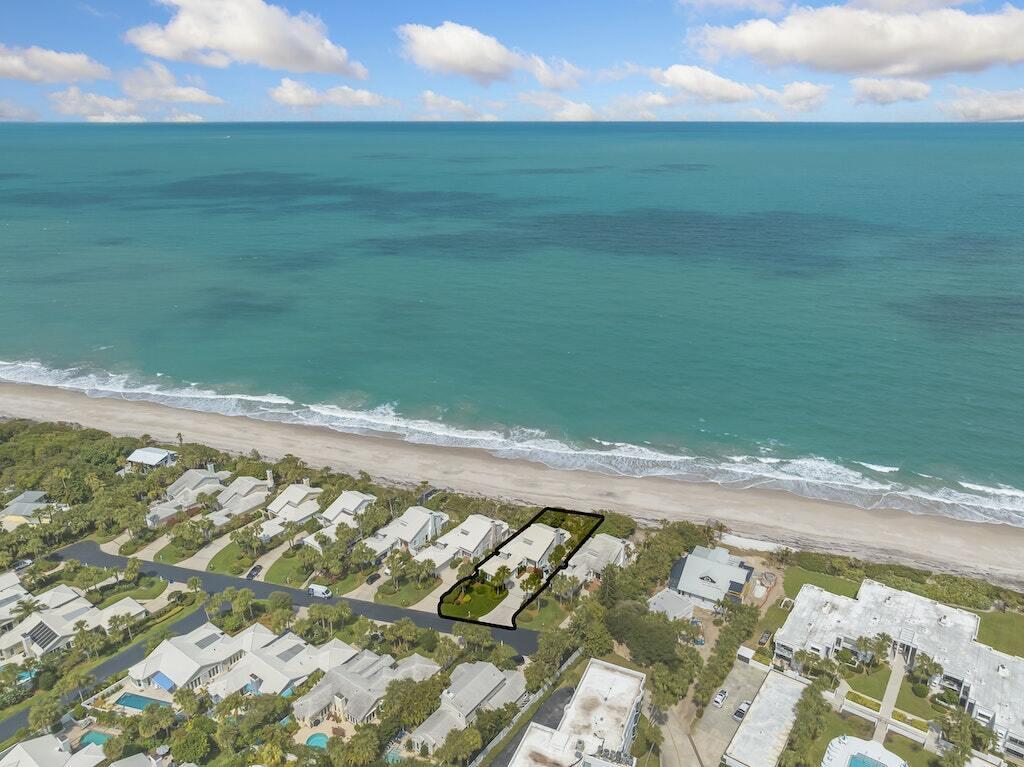 Ultimate beachside living awaits! A combination of sophistication and comfort this home's architectural features include detailed ceilings, a calming fireplace and a room intricately designed to capture both Florida's sun & peaceful ocean views. Rest assured with the impact windows, tile roof, newer AC's and water heater. The upstairs primary suite offers a bonus sitting/office area and intimate balcony with inescapable ocean views! Both first floor bedrooms are en-suite, one offering a picturesque ocean view and the other a private patio. Tesla charger! Paradise is found in Sea Forest Court.