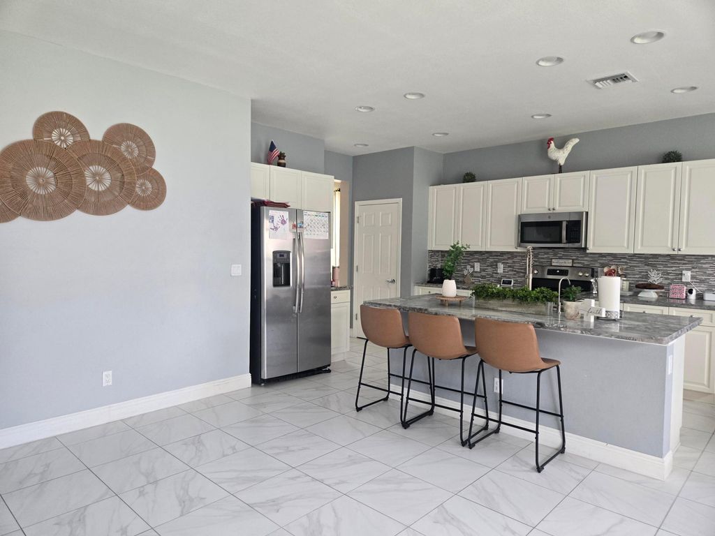 Photo of 1327 NW Leonardo Circle, Port Saint Lucie, FL 34986 (MLS # B26046607)