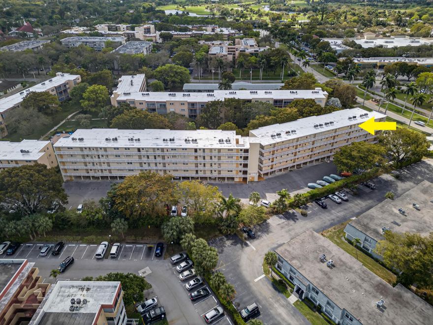 One of the town's most spacious one-bedroom units! Located in a meticulously maintained complex, this home is just a short walk to Publix, restaurants, Starbucks, UPS, the bank, and more—your own private shopping and dining district. No need to venture far unless you want to! A convenient half bath sits off the foyer entry. The oversized bedroom features two generous closets. Relax on the tiled, screened balcony with Rolladen shutters overlooking peaceful greenery. Enjoy coffee at sunrise or wine at sunset in this quiet retreat. NEW Electrical Panel,  Impact Windows and a roof under warranty until 2032 add value. 55+ community. Only this building w/in the community permits a pet, with a maximum weight of 20 lbs. See broker remarks for requirements.