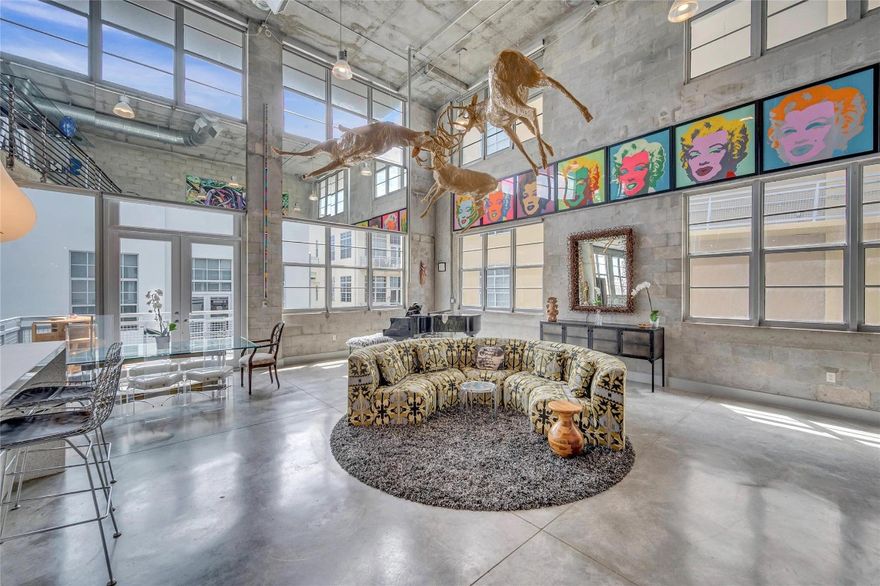 True NYC-Style Loft Penthouse in Flagler Village - Largest 2 story of its kind in the community. Ultimate urban lifestyle in this magnificent, one-of-a-kind two-story penthouse. "true" industrial loft features soaring 22-foot ceilings, impact windows, flooding the open-concept space with natural light and offering expansive city views. Aesthetic highlights include polished concrete floors, exposed ductwork, and a modern gourmet kitchen with designer finishes. Layout offers maximum privacy with 2 oversized primary suites (1 on each level). The 2nd-floor suite overlooks the living area and boasts 2 private terrace with exclusive direct access to rooftop amenities—step right out to the pool, gym, and BBQ area. 2nd park spot avail for purchase 2 pets any size, healthy building no assessments