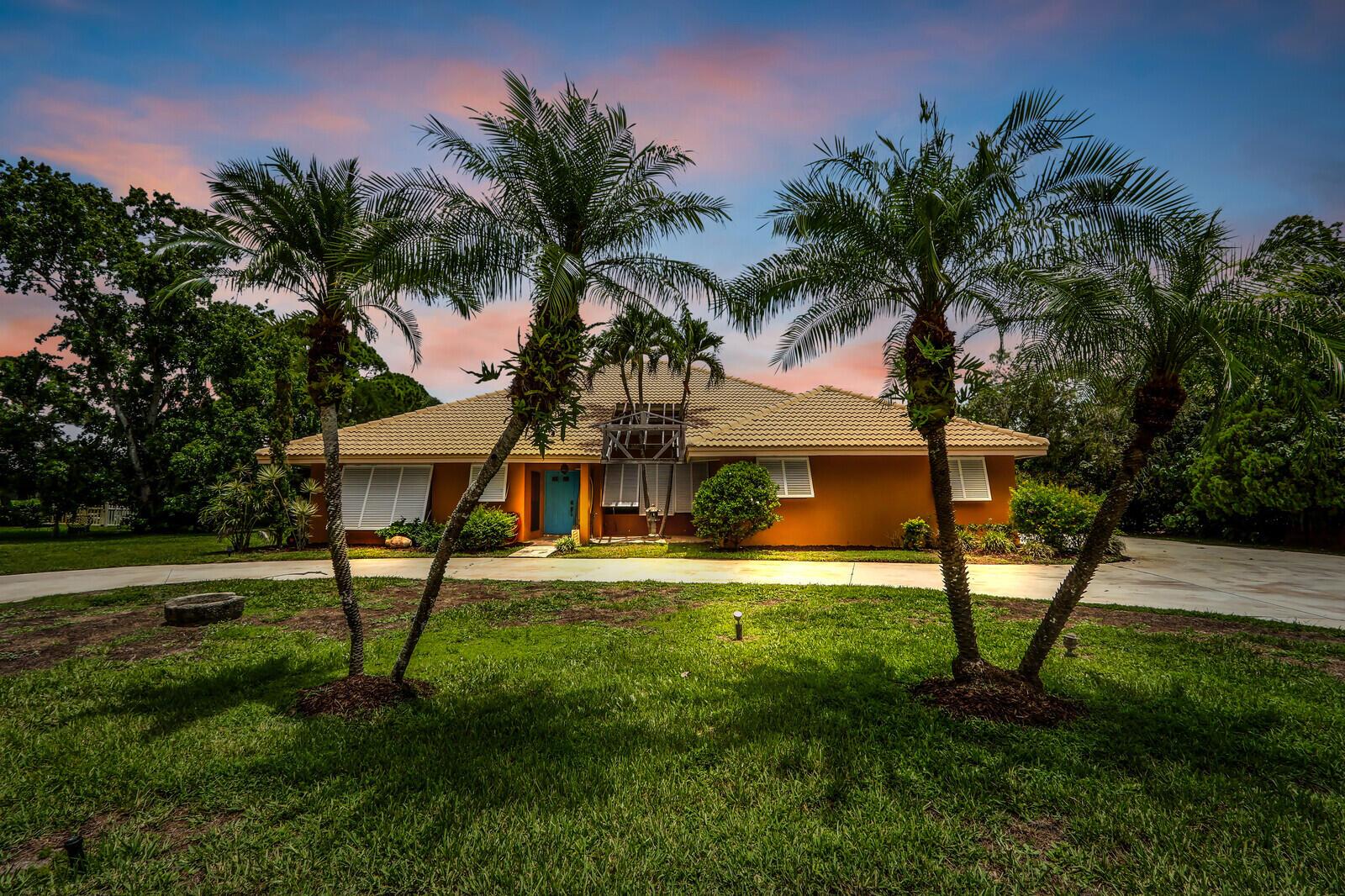 This 3 bedroom with 2 full bathroom CBS pool home is located on over an acre of property for privacy. The huge bonuses are that there is also a private dock on the C23 canal AND A PRIVATE PICKLEBALL COURT!! The home has soaring ceilings and an open floorplan. For the cook in the family there is a Viking gas stove/oven in the large kitchen. The owners suite is separated from the other bedrooms for privacy. Enjoy fishing on the canal followed by a game of pickleball and then take a plunge in the large pool and just enjoy life to its fullest! ''A'' rated schools and shopping are nearby. This home is located close to the Florida Turnpike as well as I 95 for ease of commuting or easy access to the airport and activities in West Palm Beach. The golf course is privately owned so residents do not