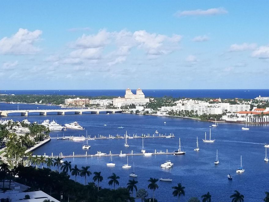 BEST VALUE! ONLY AVAILABLE 2 BED UNIT IN ONE & TWO CITY PLAZA WITH 2 COVETED GARAGE PARKING SPACES. OWNER OWNER FINANCING AVAILABLE W/ AN APPROPRIATE OFFER & REASONABLE CASH DOWN PAYMENT.SELLER ACCEPTING BACK UP CONTRACT This condo is a quintessence of modern luxury & convenience.  one of the premier residences wired for electric cars, this highly coveted 11th-floor unit is a hallmark of sustainability & modernity. Virtually Staged. Private balcony with oversized bedrooms! Resort-style rooftop pool with panoramic views of the Atlantic Ocean, majestic yachts, and the iconic Breakers Hotel. Priced thoughtfully to align with its value and the luxury it offers, this condo represents a rare opportunity to own a slice of paradise with an allure of breathtaking views, convenience of urban living valet parking  & unparalleled amenities. This luxury building has a 17th fl roof top inground pool with views of the intracoastal and Palm Beach Island, on site manager, fitness center, sauna, steam room, 7th fl courtyard w/waterfall, trash chute, renovated community room, bike storage and a stunning lobby! Parking for electric cars also available.