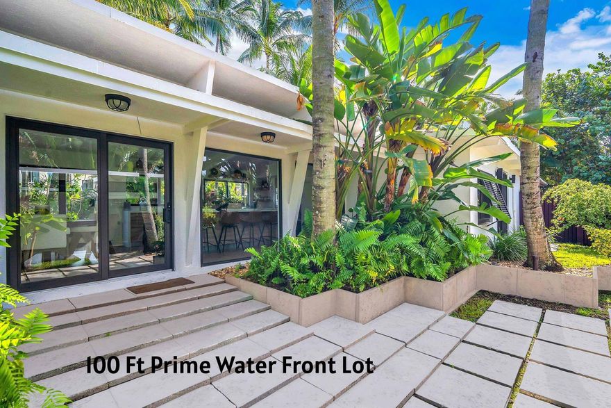 Nestled in the heart of Las Olas in Fort Lauderdale, this modern bungalow plus guest house is situated on a prime 100+ waterfront lot with deep water canal, no fixed bridges and ocean access.  Multi million dollar homes surround this lush tropical waterfront home in the most prime location.   The tropical pool area features 50 plus coconut & fox tail palm trees with a raised platform area and hot-tub for casual Florida living.  For the boating/yachting enthusiast, this prime east facing lot features a concrete seawall and dockage for 90 ft+ yacht with water and electric.  Enjoy waterfront living in this small but modern home or build your dream home on this prime lot and location or Air BNB this home. Main house 1 bedroom, 1.5 bath plus guest house with 1 bedroom, 1 bath, walk-in closet All new hurricane impact glass: ALL windows, doors and sliding glass doors with dark "espresso" frames, All New modern kitchen with custom cabinetry & countertops with waterfall island, Thermador appliances, all bathrooms remodeled with modern state of the art hardware and materials, three new mini-split ac units,  Heated salt water pool with new pump and heater, gated & fenced yard for privacy, electric shades, floor to ceiling windows in main area for natural light and views!  100+ foot concrete dock with concrete seawall cap.  Recently dredged canal to over 9' of depth at dock (2 )100 amp power pedestals New dock lights (2025) Pump Out Station Incredible Tropical oasis with incredible flora and fauna (including over 50 palm trees!) Property wide landscape lighting