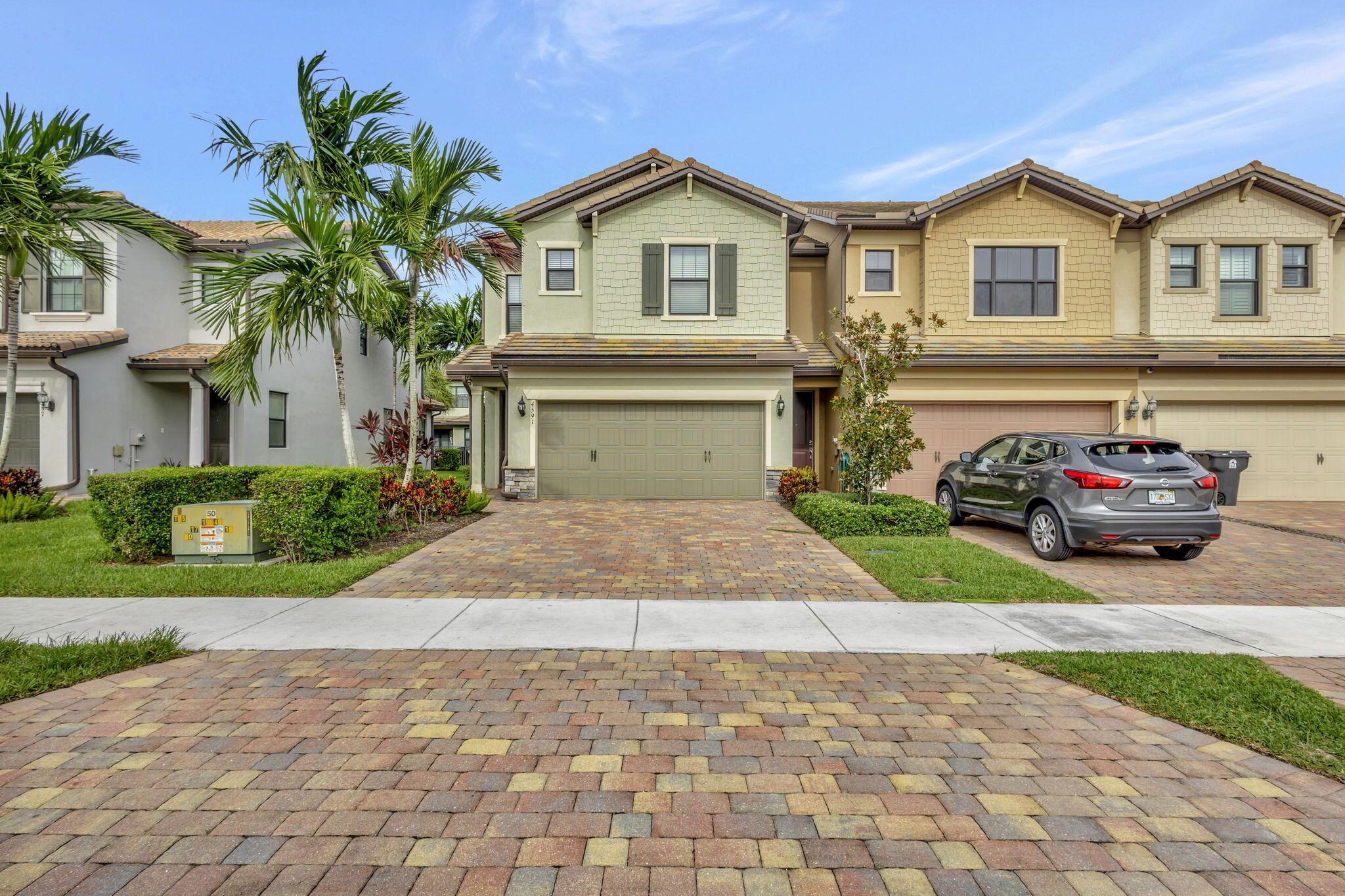 Stunning 3-bedroom, 2.5-bath corner unit in a premier gated community! This home features a spacious open layout with impact windows, a gourmet kitchen with an oversized quartz island, all stainless steel appliances, and a convenient upstairs laundry room with a sink. Enjoy the serene master suite with a walk-in closet and a luxurious en-suite bath. The property includes a 2-car garage for secure parking and extra storage. The community offers two clubhouses with resort-style pools, fitness centers, and more. Located near the Turnpike, shopping, and dining, this home blends luxury, convenience, and a great lifestyle.Brand new Carpet to the upstairs has just installed . Don't miss out!