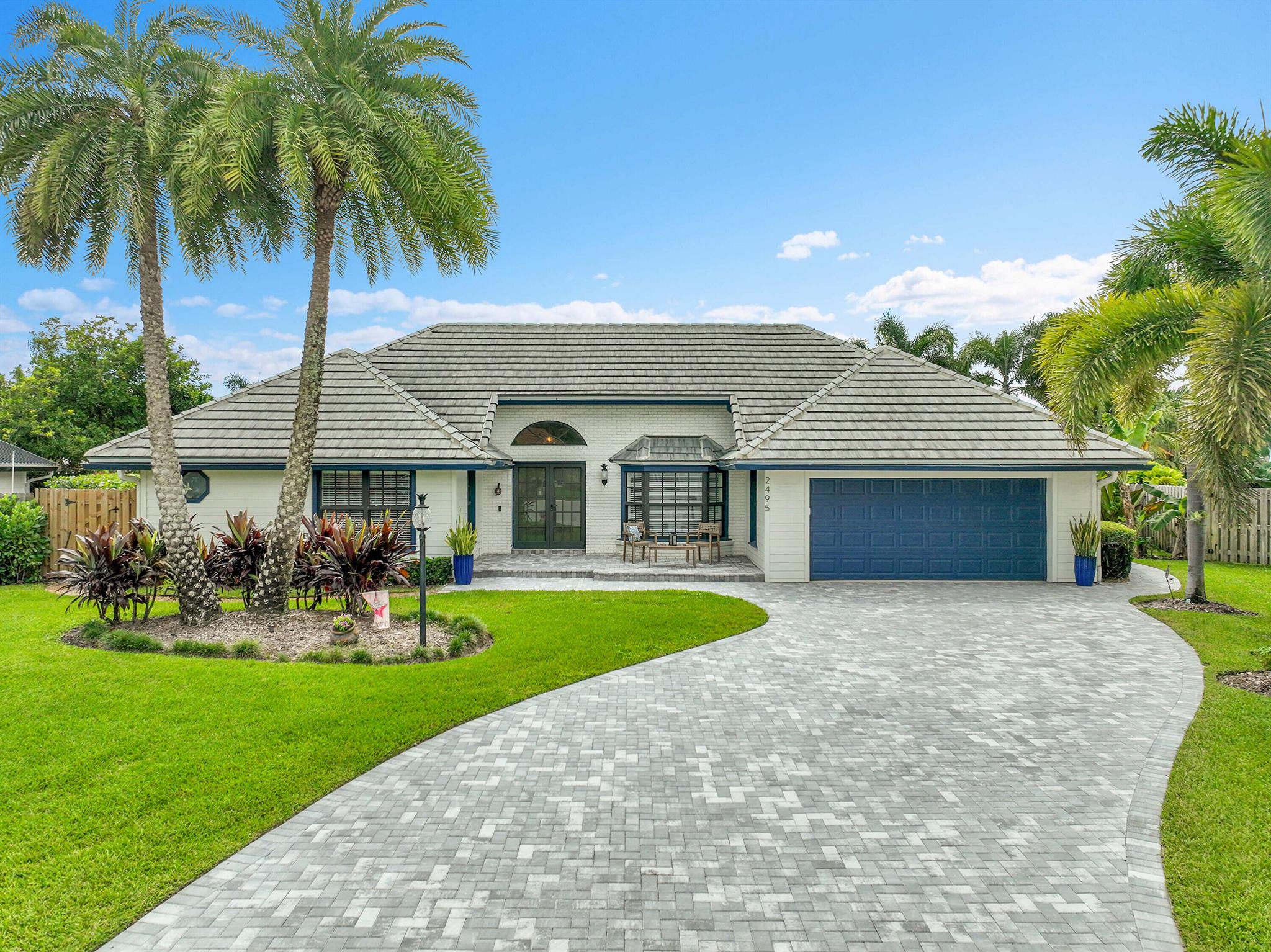 Frenchman's Fancy! Turnkey single story home w/Split floor plan. Featuring 4 Bedrooms, 2 Full Bathrooms. Vaulted Ceilings, Impact Windows, Hardie board siding, Luxury Vinyl Plank flooring. Cement tile roof (2021) New AC (2024), Tankless HWH (2022). Open kitchen concept w/White shaker-style cabinetry and newer granite countertops. Eat-in breakfast nook and top of the line, stainless steel kitchen-aide appliances. The Kitchen overlooks the Great room and features a wood burning fireplace. Formal dining room features Pecky Cypress Synergy wood ceilings. Owners' suite features renovated bathroom w/separate soaking tub & shower and huge walk-in closet. The backyard is fully fenced w/saltwater pool encased with Travertine Pavers. Covered Lanai features Pecky Cypress synergy wood ceiling