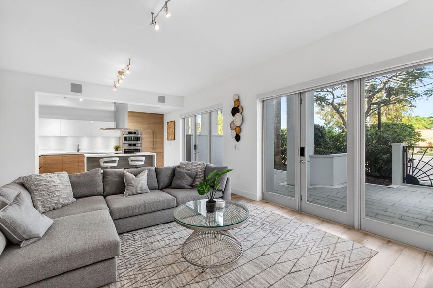 Experience refined townhouse-style living in the heart of Downtown Boca Raton, where modern design meets full-service luxury. This exceptional two-level residence spans over 2,500 square feet and features 3 spacious bedrooms and 3.5 beautifully appointed bathrooms. Bathed in natural light from its desirable eastern exposure, the home showcases soaring 10-foot ceilings and elegant Italian porcelain tile flooring throughout.  The chef-inspired kitchen is a striking focal point, featuring handcrafted Italian cabinetry, sleek quartz countertops, and a custom waterfall island. Top-of-the-line Bosch appliances—including a double wall oven and wine refrigerator—make this space ideal for both everyday living and entertaining.  Each bedroom offers the ultimate in privacy and comfort with its own en suite bath and custom walk-in closet. The spa-like bathrooms are thoughtfully designed with floating vanities, Moen fixtures, Kohler tubs and toilets, frameless glass shower enclosures, and full-height mirrors, creating a serene, elevated experience. Hurricane-impact windows and doors provide both security and peace of mind.  A rare private entrance leads to your own outdoor yard—perfect for pets, children, or simply enjoying a tranquil retreat.  This residence includes two assigned garage parking spaces and grants access to the exceptional amenities of Tower 155. Residents enjoy a rooftop sundeck overlooking Mizner Park with private cabanas and a hot tub, a resort-style pool, state-of-the-art fitness center, spa room, club room, and a grand two-story lobby. Full-service living is enhanced by 24-hour concierge and valet services.  Ideally located just moments from Mizner Park, Royal Palm Place, Boca Raton's premier dining and shopping destinations, pristine nearby beaches, and private aviation facilities, this home offers an unmatched blend of sophistication, comfort, and convenience.