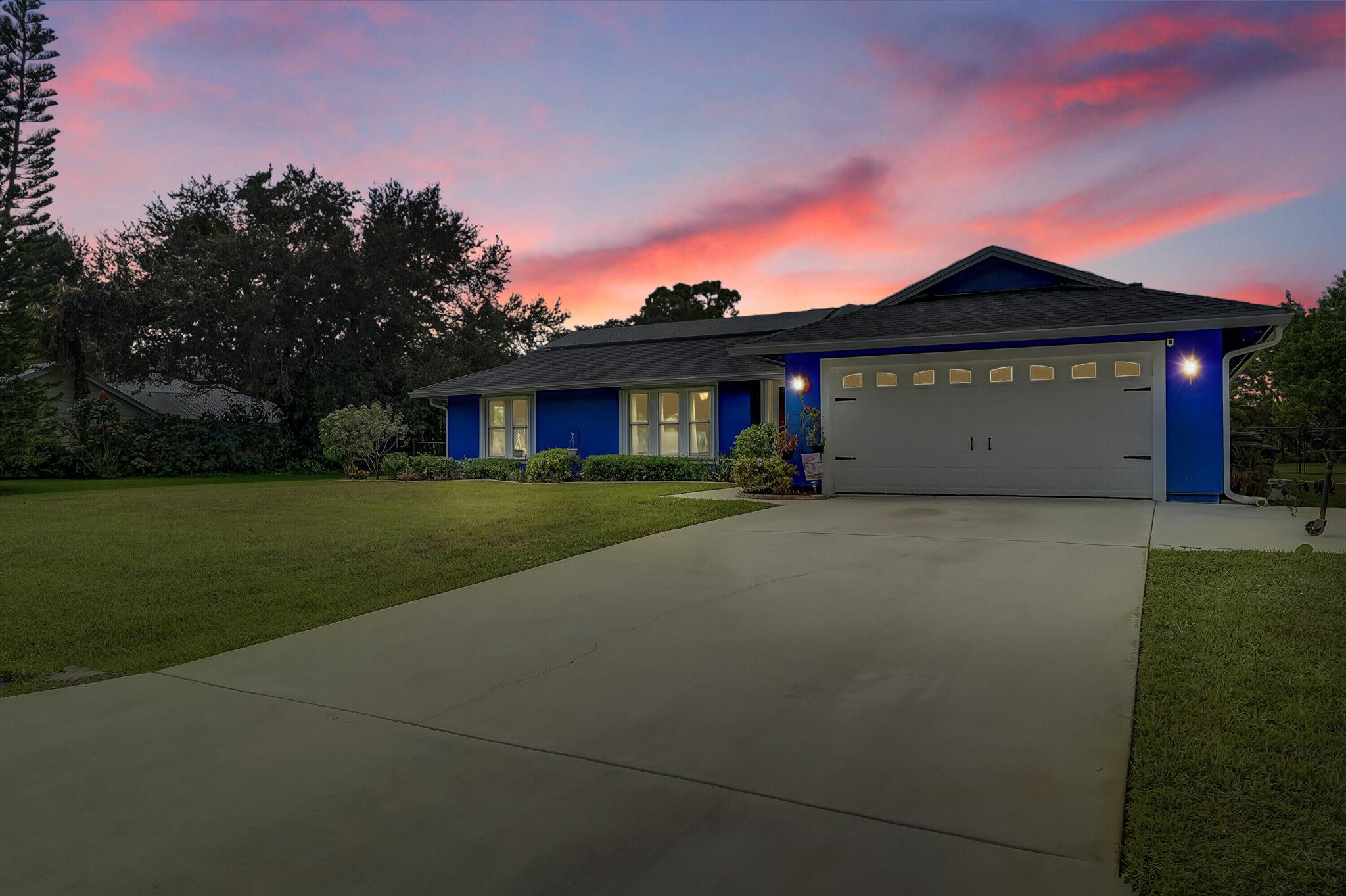 Welcome to your dream Florida home, perfectly located in the highly desirable Sandpiper Bay community, just minutes from top-rated shopping, dining, golf, and the beautiful shores of Jensen Beach. This meticulously maintained 3-bedroom, 2-bath home is nestled on a generous 1/2-acre lot with lush landscaping, fruit trees, and serene pond views right across the street. Designed for both comfort and entertaining, the home features a screened-in pool and a covered patio, complete with a pass-through window to the kitchen--perfect for indoor/outdoor living year-round. Recent updates bring peace of mind and modern convenience, including a 2021 roof, high-efficiency A/C and water heater, new gutters, and numerous