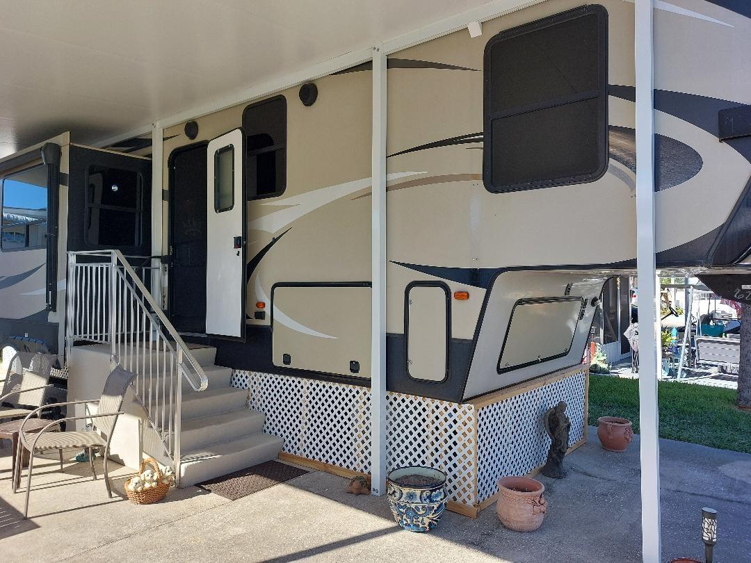 This immaculate 5th wheel has a brand new split system for cool ac this summer! Bring your swim suits and bikes. Roof has been recently coated. Friendly neighborhood has lots of adult activities. Close to marina for boating and fishing. Close to pool and pickleball. Pride in ownership shows! Owner has taken such great care with this home. Plenty of parking. You own the land. Owner has just added new stairs and underskirting to home. Come check it out!
