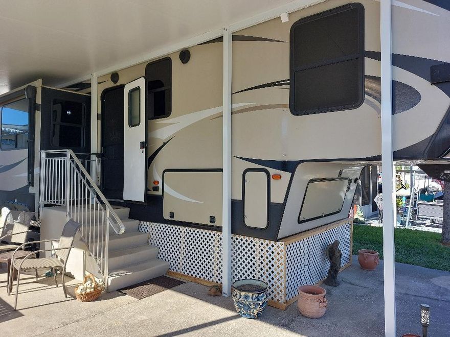 This immaculate 5th wheel has a brand new split system for cool ac this summer!  Bring your swim suits and bikes.   Roof has been recently coated.  Friendly neighborhood has lots of adult activities.  Close to marina for boating and fishing.  Close to pool and pickleball. Pride in ownership shows!    Owner has taken such great care with this home.  Plenty of parking.  You own the land.  Owner has just added new stairs and underskirting to home.  Come check it out!