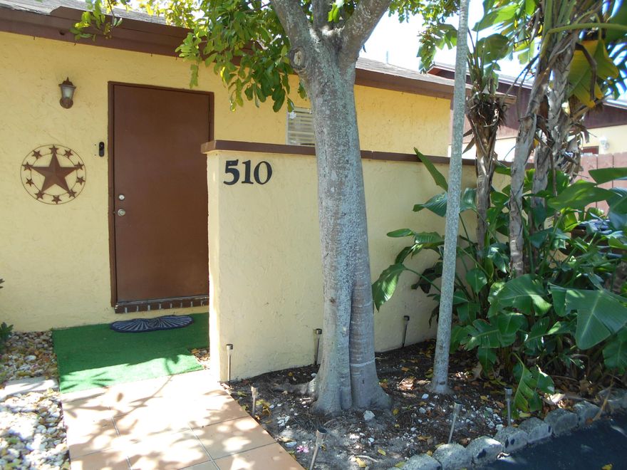 Beautiful 2/2 corner villa in a pet-friendly community! This home features an updated kitchen and refreshed baths, plus a fully renovated second bedroom with an added sitting area—perfect reading a good book. Enjoy a private fenced backyard overlooking a wide and tranquil canal, complete with a wood deck, pull-out awning, and storage shed. French doors bring in natural light and lead to your outdoor space. Utility room includes full-size washer/dryer and a stand-alone freezer. Driveway fits up to 4 cars. Community amenities include clubhouse, pool, tennis, sauna, gym, billiards & more. Low HOA—just $130 quarterly!  This community is investor friendly and allows immediate rentals.
