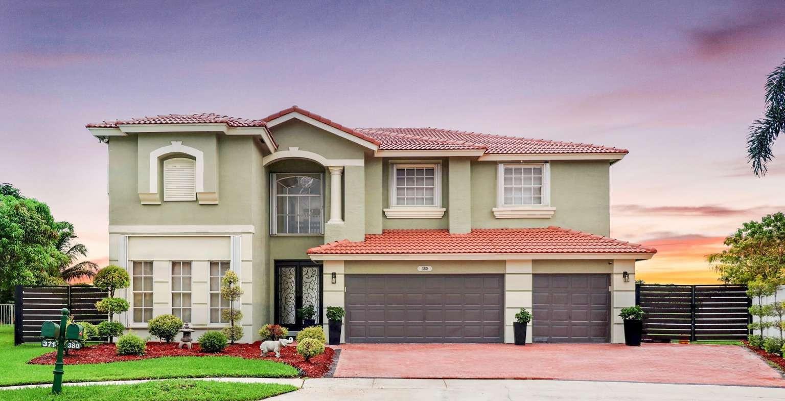 Experience timeless elegance and modern comfort in this exceptional home within the prestigious guard-gated community of Pembroke Shores. Perfectly positioned on the most coveted cul-de-sac, it offers both serenity and stunning curb appeal. An oversized paver driveway leads to a 3-car garage with custom storage. Inside, soaring ceilings, natural light, and stylish lighting enhance the open layout. The renovated gourmet kitchen boasts quartz counters, a massive island, and premium finishes. This 4-bedroom home features a first-floor suite, grand upstairs master with balcony, and renovated bathrooms. Step outside to your oversized pie-shaped lot with stunning sunrise and sunset views, perfect for entertaining. Near “A” schools, shopping, fine dining, highways, and hospitals.