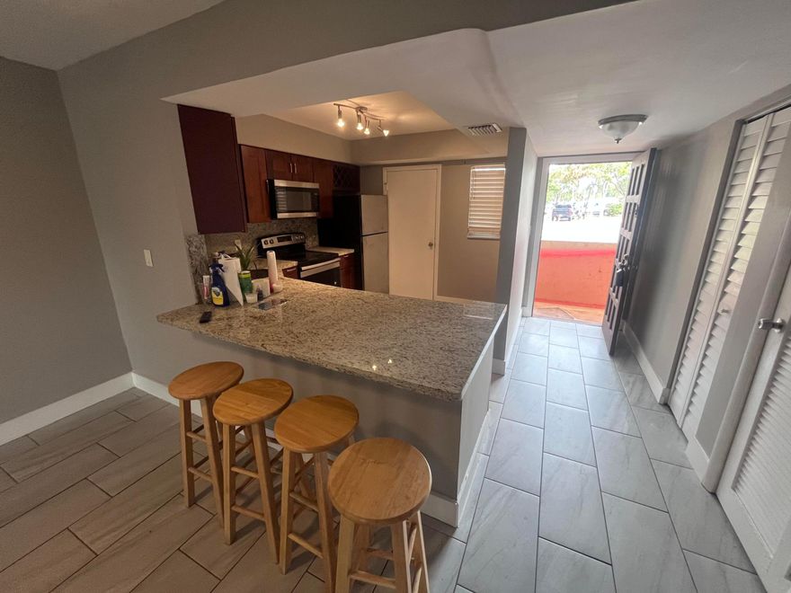 Bright and nicely updated 2 bedroom 2 bathroom ground level unit, split floor plan, parking space up front, stainless steel appliances, Modern kitchen with granite countertops, tile flooring throughout, large primary bedroom with a walk-in closet. Guest bedroom is spacious with ample closet space, Bathrooms include, shower & bathtub with granite counter tops, This all-ages community offers a pool, gated security, and includes basic cable and water. #111 is Move-in ready and easy to love!