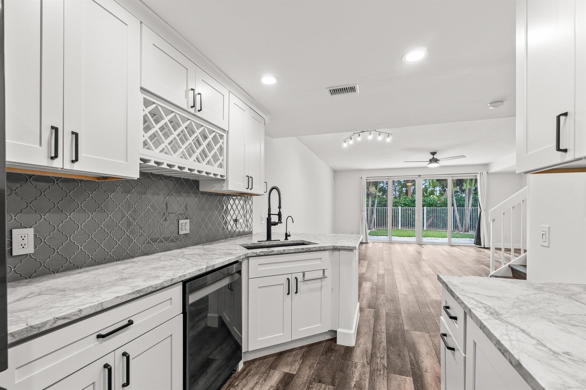 ANNUAL, UNFURNISHED RENTAL $3,750/month. Recent upgrades include a tankless water heater, A/C, impact windows/doors, new cabinets, countertops, luxury vinyl flooring (no carpet), and a turfed backyard. washer/dryer room. Primary suite has separate shower and tub. All built-in closets. The garage is air-conditioned for extra comfort. 1 car garage with 2 outdoor spaces. This renovated home sits on a desirable cul-de-sac near guest parking, just steps from the heated community pool, pickleball, and park. Located in Catalina Lakes, enjoy close proximity to top golf courses, The Gardens Mall, dining, and just a short drive to Juno Beach and Singer Island.