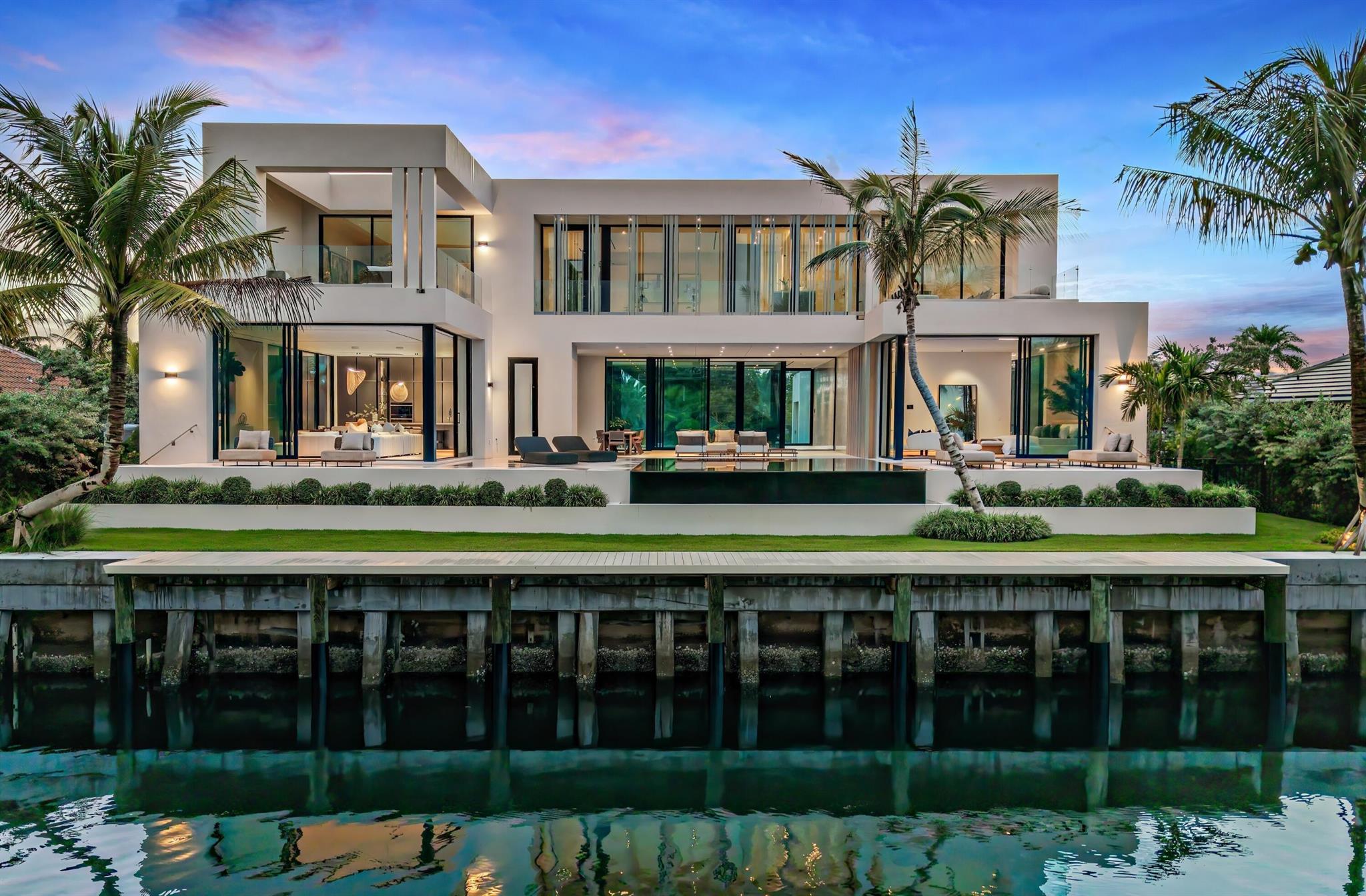 Meticulously designed, 35 Spoonbill Road is a new six-bedroom Point Manalapan estate blending museum-like minimalism with warm luxury. With 111 feet of private Intracoastal frontage and uninterrupted water views, privacy is unparalleled. Ocean Blue Custom Homes delivers a one-of-a-kind residence with an olive tree atrium, dual kitchens, knife-edge pool, outdoor shower garden, and deepwater dock.