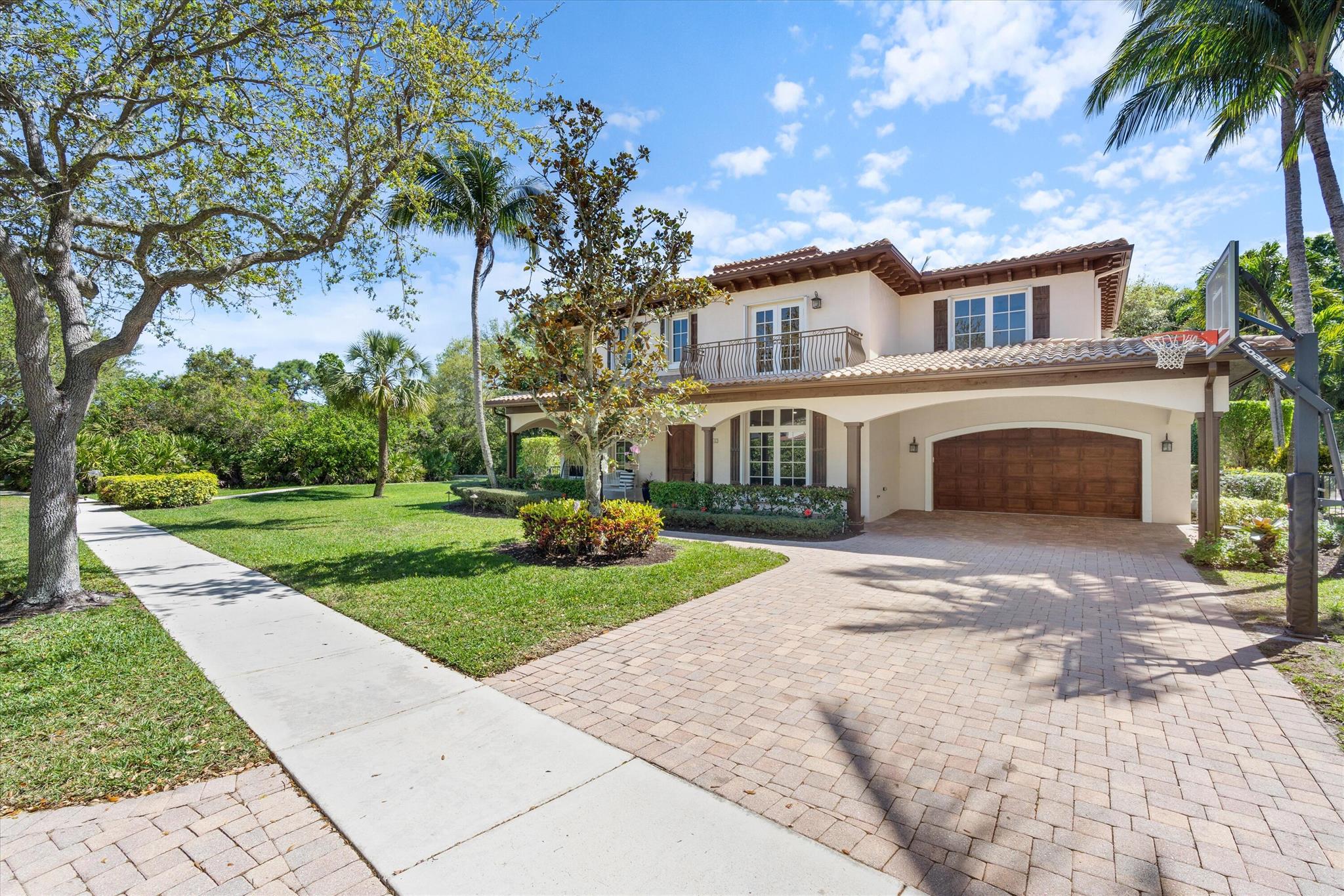 Welcome to this stunning Mediterranean-style 5-bedroom, 4 1/2 bathroom home, nestled in one of the largest corner lots of the highly sought-after Valencia neighborhood at Abacoa. Surrounded by beautiful greenery and showcasing striking curb appeal, this home includes a covered front porch, arched entryways and a second floor balcony that adds elegance, making it stand out in the neighborhood. This private residence offers a perfect blend of space, style and functionality.The home has been meticulously renovated, with a beautifully updated first floor that features an open, light-filled layout with soaring 20-foot ceilings. New oak hardwood floors throughout the entire home provide a sleek, modern touch. The chef's kitchen is a true highlight, featuring luxurious Cristallo countertops