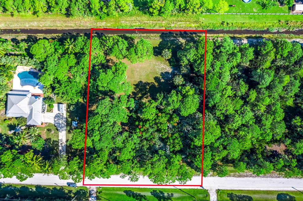 This 1.29 acre, high & dry lot is waiting for you to clear some tress and build your dream home! Agriculture & residential area, one lot away from the end of the street, which has a wide canal, so not a high traffic street.Everything the Acreage and Loxahatchee has to offer, yet on the east side of the community, to be in West Palm Beach