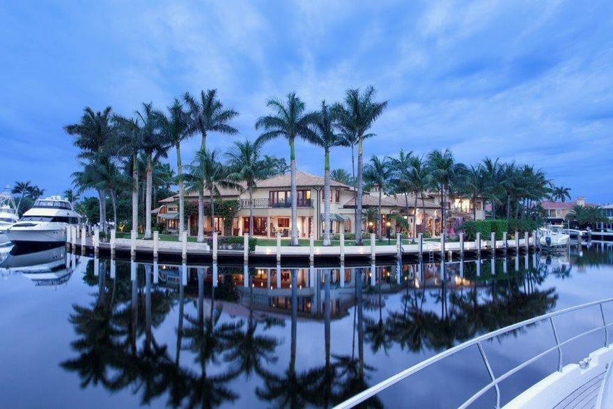 An idyllic resort-inspired paradise, this rare double point compound sprawls across 400± ft. of shoreline commanding panoramic palm-framed views at the basin-like confluence of two waterways. Multi-yacht dockage is minutes from the inlet. The lavish main residence and separate guest house are newly reimagined with a fresh look. Impressive great room, family/media room, club room with professional-style bar. Grand first-floor master suite. Exotic pool patio with rock waterfalls, grotto and slide.