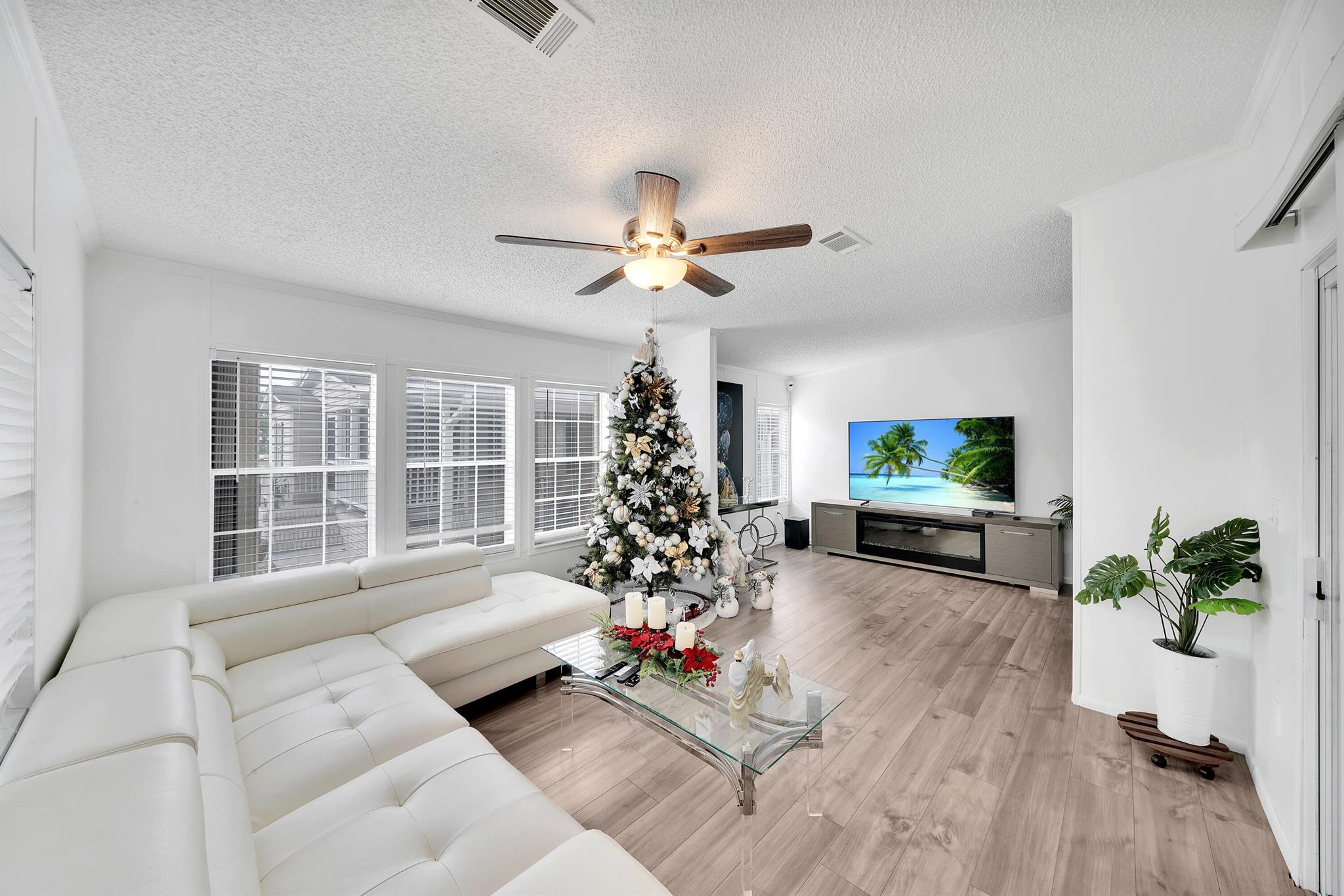 Welcome to this beautifully renovated 2005-built manufactured double-wide home located at 139 Winter Park Lane in the desirable Garden Walk community of Palm Beach Gardens. This all-age community offers a quiet and well-maintained neighborhood with amenities including a swimming pool and clubhouse. This spacious home features 3 bedrooms and 2 bathrooms, with new flooring, fully remodeled kitchen equipped with new appliances, updated bathrooms, fresh interior paint, and an attached screened-in room perfect for relaxing. Additional features include a covered carport and a cozy front porch.The affordable monthly fee of $1,030 covers lot rent, water, and property taxes, totaling approximately $1,150.