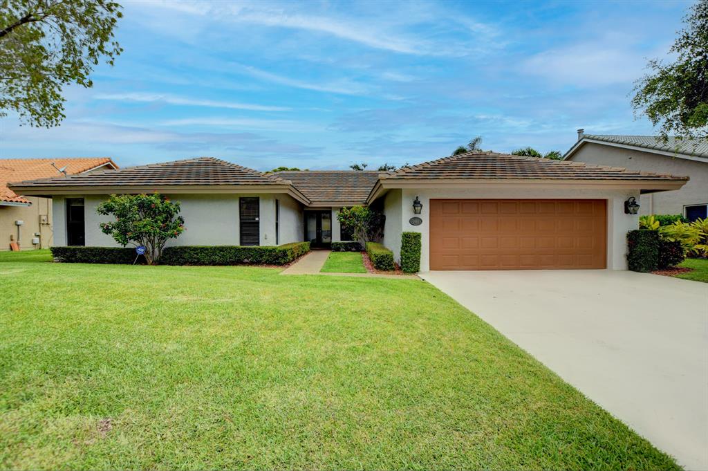 Bright, open, updated 4 bedroom 2.5 bath pool home with no backyard neighbors in East Boca in. This house has been extremely well maintained with updated kitchen, baths, wood flooring, newer roof, impact windows and so much more. You will enjoy the large island kitchen and family room right off the covered patio. The separate living room provides views of the back as well as the pool. Excellent location, A rated schools and easy access to shops, beaches and parks.