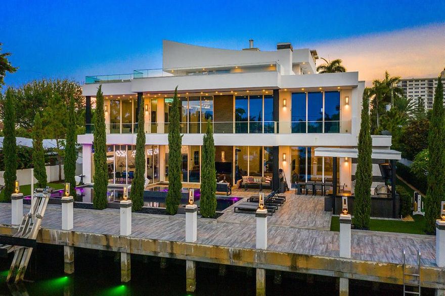 Gorgeous gated home located in the prestigious waterfront community of Seven Isles. This stunning contemporary masterpiece features 6 bedrooms, 7.2 bathrooms,an office, media room, gym, loft, separate gazebo with brand new black granite summer kitchen and Lynx Stainless Steel grill,roof terrace, Savant smart home technology, Lutron lighting system, indoor/outdoor security camera system, 2 garages with room for 4 cars, lift installation ready if needed to accommodate 8. Custom 10' interior doors, 11' tall insulated and impact glass doors. Brand new sea wall and concrete dock. Oversized salt water pool & jacuzzi with pebble tech finish and LED lighting and outdoor gas fire pits. Features a brand new, never used, boat lift for up to 27,000 lbs. Just steps to Las Olas or Fort Lauderdale Beach.