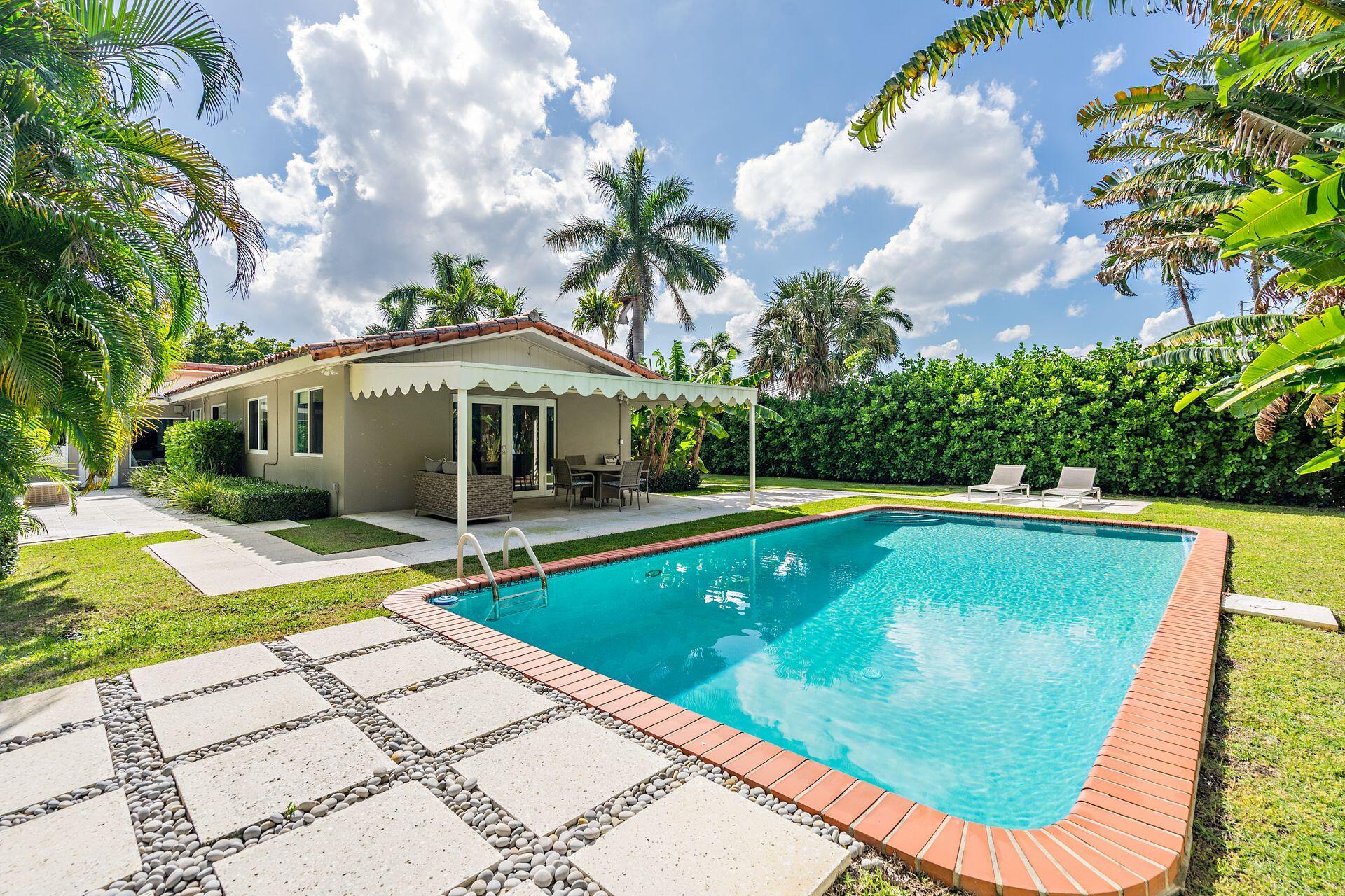 Rental in the heart of the Southend - Steps from the Intracoastal. Available furnished for annual or seasonal lease, this 3-bedroom, 2.5-bath home sits just one block from the water on an oversized 75' x 160' lot. The light-filled interior features oak hardwood floors, impact windows, and a spacious, intuitive floor plan, including a two-car garage. French doors open to a generous private yard, oversized pool and covered loggia, perfect for year-round Florida living..
