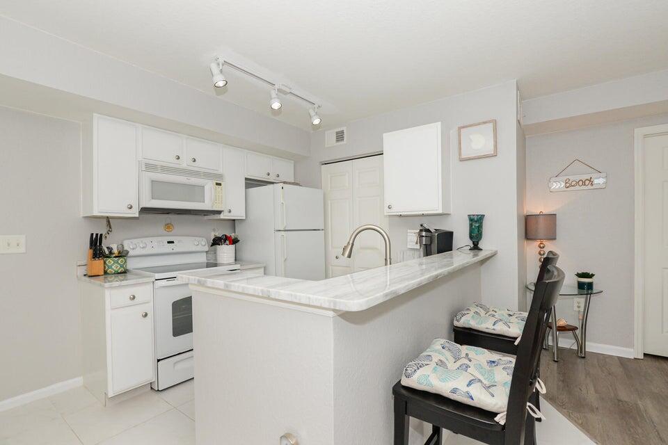 Totally Updated, New Roof (May 2025) and New AC....tastefully decorated 2/2 condo in The Club, granite kitchen, tile floors, new paint. Easy to show.