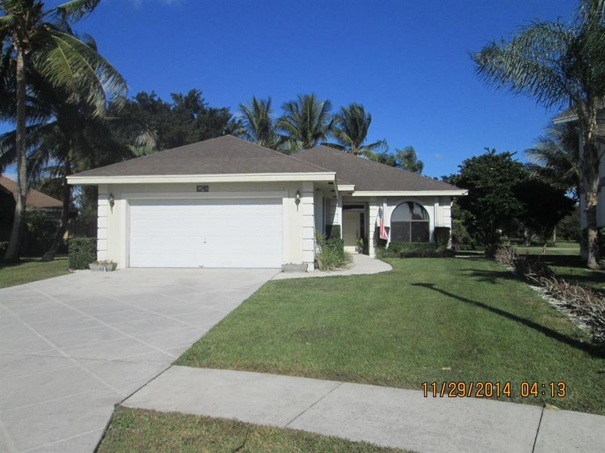 This Beautiful home has been updated. Granite counters and rich wood cabinets, tucked in a cul-de-sac with lake frontage.  Three bedrooms with a ''den'' that could be a 4th bedroom or playroom or office.  Large screened patio and large fenced yard. Large inside laundry room with full sized washer & dryer.  2 car garage. Great Community in a fabulous school area.  Close to great shopping, restaurants and just minutes to beautiful white sandy beaches