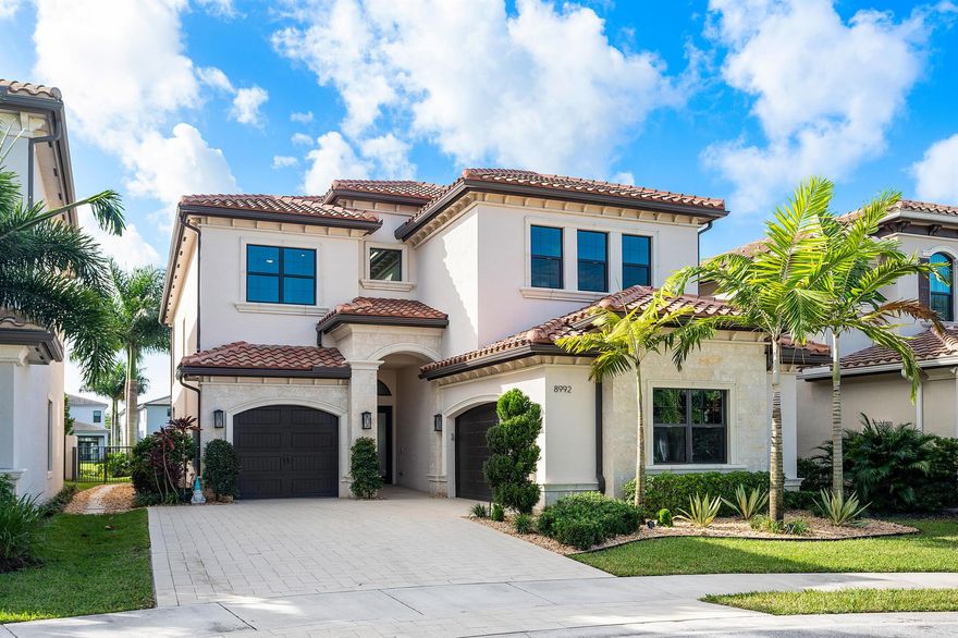 Nestled in the prestigious Boca Bridges community, this designer-decorated and extensively upgraded Florence model seamlessly blends luxury with comfort. With five bedrooms and five full bathrooms, this home boasts timeless architecture and meticulous craftsmanship at every turn. The open-concept design effortlessly connects the living, dining, and kitchen areas, creating a perfect setting for both grand entertaining and intimate family gatherings. The chef's kitchen stands as a culinary masterpiece, featuring top-of-the-line appliances, custom cabinetry, and premium finishes. Ascend to the second floor to find beautiful white oak flooring that adds warmth and sophistication, along with bonus room currently used for the ultimate entertainment experience. The luxurious