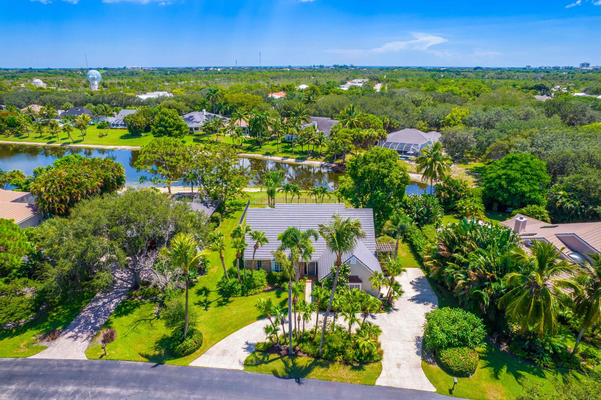 Nestled in the picturesque, tree-lined community of River Ridge, this inviting home blends comfort, style, and convenience. Set on a peaceful lake and just minutes from the beach, it offers a relaxed Florida lifestyle in a private, gated setting. Brand new 2025 Roof. The primary suite is located on the main floor and features plantation shutters, a large walk-in closet plus a built-in closet, and a spacious master bath. It also connects to a versatile flex room that works perfectly as an office, nursery, or guest space. The living room is filled with natural light with soaring ceilings, creating an open, welcoming atmosphere for everyday living or entertaining. Sliding doors lead to the covered patio and pool area--an ideal spot for sunsets and entertaining. SEE MORE...