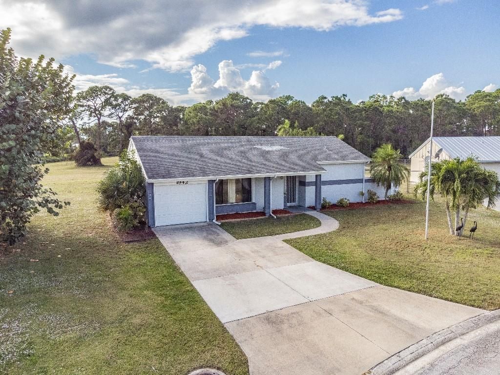 Photo of 1942 SE Burgundy Ln, Port Saint Lucie, FL 34952 (MLS # F10311043)