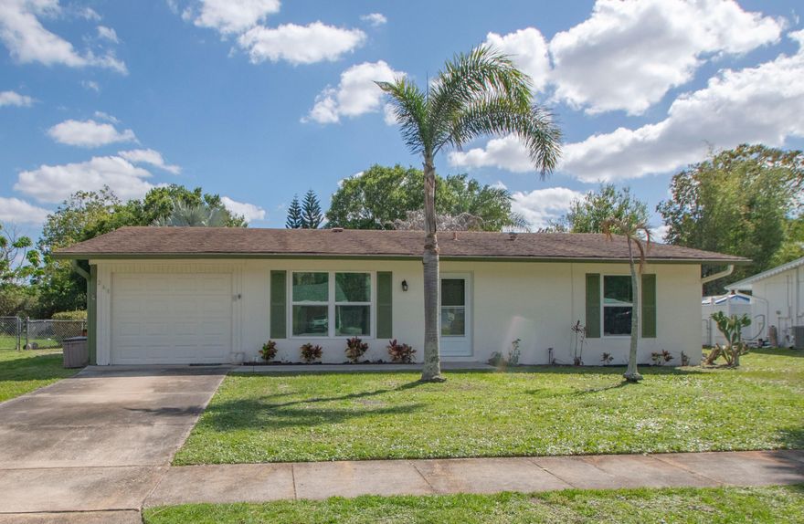 This cute 2/2/1 is a perfect starter home or investment property in the middle of Port St Lucie. Close to everything... parks, shopping, restaurants, houses of worship and a new library coming soon.  Florida room was enclosed to add almost 300 sf to living sf. Hurricane/Impact windows installed in 2024. CBS Construction. AC and Pest Service done regularly. Big fenced back yard has plenty of room for a pool. Sold AS-IS. All sizes approximate, buyer/buyer's agent to verify.  Magnolia Tree in back yard does not convey.