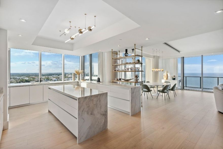 One of a kind combination corner residence at the new Auberge Beach Residences. Original owner combined two units into the most spectacular 5 bedroom, 5 bath unit with 4,241 sq/ft of interior living space. Professionally designed by DKOR Interiors, no expense was spared when finishing the unit with custom built-ins, wood flooring, closets, window treatments and furnishings. The 180 degree views from this NE corner flow-thru unit include direct ocean, intracoastal and downtown views. The kitchen was custom designed to be one of the largest at Auberge and includes an island, 2 full size wine coolers and gas cooktop. 4 parking spaces included. Auberge offers 5 star amenities including: upscale restaurant and spa, fitness center, two pools, cinema, golf simulator, billiards, wine room etc