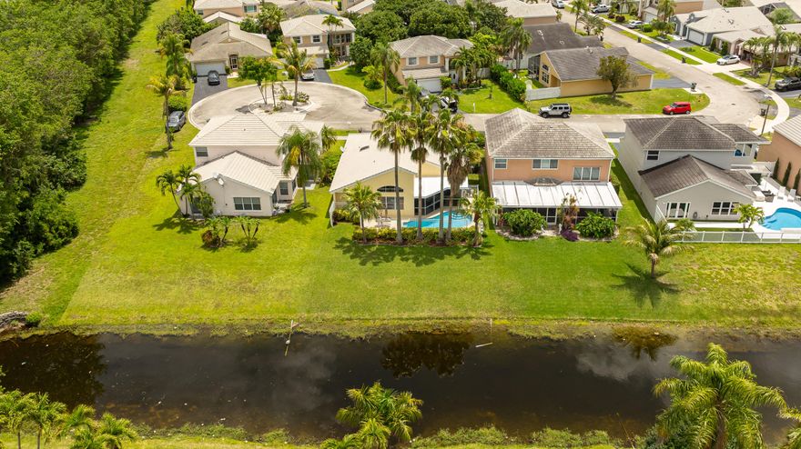 Welcome to Lauren's Turn! If you've been searching for that easy, laid-back Florida lifestyle, this is it. This beautifully maintained pool home in northern Coconut Creek welcomes you w/ soaring vaulted ceilings & a bright, open feel from the moment you walk in. The updated kitchen shines w/ white cabinetry, quartz counters, & a marble tile backsplash. Unwind on your covered, screened patio or spend weekends by the freeform pool. The split bedroom floor plan offers a spacious primary suite w/ vaulted ceilings. Other great features include tile throughout the living area, updated 2nd bathroom, crown & decorative chair rail molding throughout plus your own pineapple garden! The lot provides added privacy backing to a canal & tucked away on a quiet cul-de-sac. This one just feels like home!