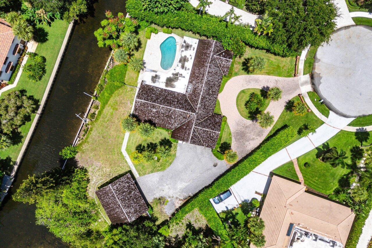 ONCE-IN-A-LIFETIME WATERFRONT OPPORTUNITY - OVER 280 FEET OF FRONTAGE IN HIDDEN KEY! Located at the end of a private cul-de-sac in the prestigious gated community of Hidden Key, this expansive property offers more than 280 feet of waterfront and backs to the exclusive enclave of Captain's Landing--providing unmatched privacy and scale. The lot currently features a 3-bedroom, 3-bath, 2car garage, pool home with formal living and dining rooms, a large family room, and a partially surrounding screened patio for indoor-outdoor living. While the existing structure offers a spacious footprint, it is best suited for a complete renovation or teardown, giving the next owner the chance to build a spectacular custom estate in one of North Palm Beach's most sought-after waterfront communities.....