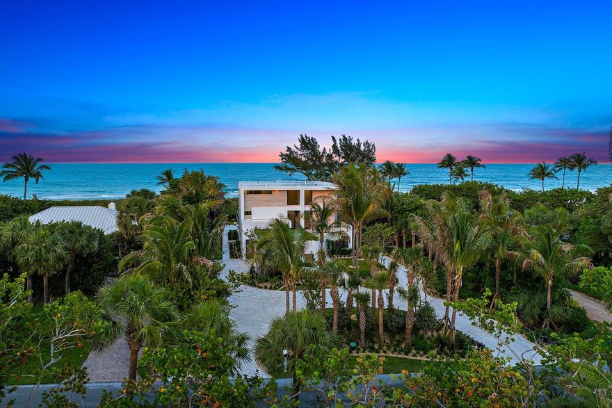 Introducing a brand-new 2025 oceanfront estate on Jupiter Island, offering 100 feet of unobstructed beachfront and a thoughtfully designed modern coastal aesthetic. Crafted by Lendalk Properties and redesigned by Olsson Design, this modern coastal residence offers approximately 8,000 total square feet (6,000 under air) with four bedrooms, five full and two half baths, a den, and a three-car garage with golf-cart bay—thoughtfully designed for effortless family living and refined entertainment. The heart of the home is the open chef's kitchen, perfectly suited for daily gatherings and hosting, featuring dual islands, Cristallo countertops, custom cabinetry, Sub-Zero refrigeration, a Wolf gas range, wet bar, oversized pantry, and extensive built-ins. The primary suite is a peaceful oceanfront retreat with a spa-inspired bath, expansive his-and-hers closets, and a private balcony overlooking sweeping Atlantic views. Guest suites are privately positioned with abundant natural light, ideal for children, guests, or multi-generational living.
Built for strength and peace of mind, the residence features CBS construction, concrete floors and walls, hurricane-rated floor-to-ceiling glass, a dramatic 10-foot pivot entry, hurricane-rated garage doors, whole-house generator, private elevator, smart-home automation, and custom California Closets throughout. Additional highlights include a temperature-controlled, floor-to-ceiling wine cellar and advanced security and comfort systems.
Outdoor living is exceptional, with a resort-style pool and spa, sculptural water features, a generous 1,500-square-foot covered patio ideal for outdoor dining and family gatherings, and an expansive deck that opens directly to a quiet stretch of beachperfect for morning walks, playtime, and sunset evenings.
Located just minutes from Bridge Road's dining and boutiques and within easy reach of Jupiter, Palm Beach, Apogee Club, Palm Beach International Airport, and Witham Field, this estate offers privacy, sophisticated coastal design, and an extraordinary beachfront lifestyle designed to be enjoyed for generations.