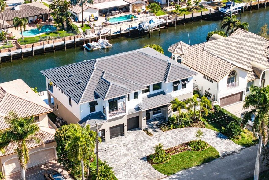 Presenting 4140 NE 23rd, a Coastal Contemporary waterfront masterpiece nestled in the charming seaside city of Lighthouse Point. Anticipated for completion by the end of spring 2024, this exquisite Waterfront Property boasts 85 feet of prime frontage and a wide to accommodate any size yacht.Indulge in the allure of a phenomenal floor plan, featuring 6 elegantly appointed bedrooms, 6.1 full bathrooms, a captivating clubroom/movie room, and a guest bedroom on the first floor. The first floor seamlessly blends indoor and outdoor living with a full open concept, showcasing a kitchen with designer appliances, dining, and living room that extends parallel to the backyard. Massive sliders lead out to the backyard and summer kitchen, offering a picturesque view of the waterfront.