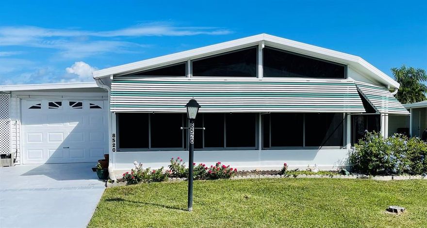 Come take a look at this ** LAND OWNED** 2/2/1 in Savanna Club an over 55 community that can also be sold **FULLY FURNISHED.**  This home has a wonderful 26x12 enclosed front porch.  When you walk thru the front door you will see an open living room and recently updated kitchen.  An interior laundry room that leads to a  bonus enclosed porch/room with a window AC. The Primary Bedroom has a large walk-in closet and a shower in the bathroom. Savanna Club has many amenities, 3 pools, library, golf course, gym, restaurant, and many others.