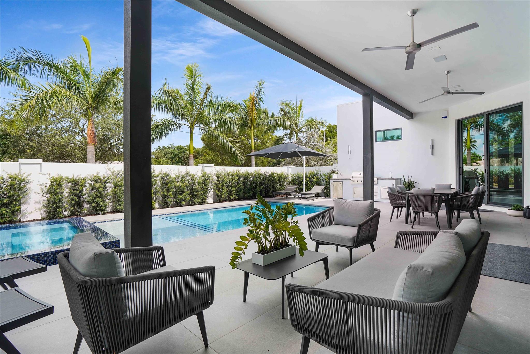 Completed in 2024, this luxurious modern estate at 300 NE 21st Ct, Wilton Manors is just one block from Wilton Drive. Enter through a dramatic 11-foot custom mahogany front door into an open design with 11-foot ceilings, 10-foot sliding impact doors, and solid concrete construction. The home features an 18-foot kitchen island, linear AC grills, electric toilets, and a full security system with cameras. Bedrooms open to a private backyard oasis with a 32x12 heated saltwater pool, spa, sunshelf, and built-in outdoor BBQ area. Primary suite offers a steam shower, soaking tub, and dual vanities. Spacious 3-car garage. Walk to shopping, dining, nightlife, and more.