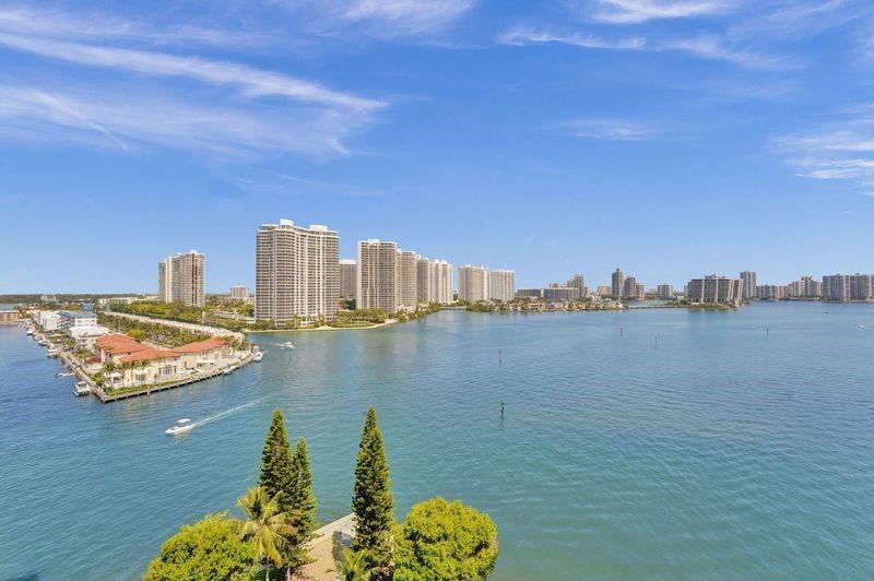 Seize this rare gem in Sunny Isles Beach, where this condo's stunning bay views and layout at this price point are a Miami rarity. Ideal as a vacation home for or a year-round haven, it features an updated kitchen, floors, and bathrooms, all completed with permits. The smart split floor plan is a perfect blend for entertaining, a home office, or family living. The building boasts newer elevators, updated balconies, and exciting resort style pool renovations. Enjoy the fully equipped gym and well-maintained tennis courts. 15 minute walk to pristine beaches and surrounded by multiple houses of worship! Located near Aventura Mall, Bal Harbour Shops and so much more. This condo offers the beauty, convenience, and value that's hard to come by in the heart of Sunny Isles Beach!