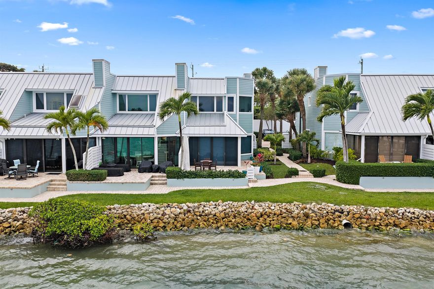 Discover the charm of Key West style living in this stunning end unit with 3 bedrooms 2.5 bathrooms & one car finished garage with epoxy flooring  on the intracoastal in Jupiter.  The home offers expansive water views from almost every room,  a brand new boat dock in 2025, updated kitchen & bathrooms ,top of the line stainless steel applicances, Cambria quartz counter tops, Bremtown cabinetry with EuroSlab soft close design, impact windows, motorized solar shades & much more.