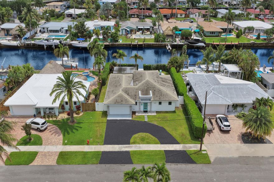 Stunning 2020-built 3BD/2.5BA pool home with 70 ft of waterfront and easy ocean access, perfect for embracing the boating lifestyle. A dramatic entry opens to soaring volume tray ceilings, a bright open layout, and breathtaking water and pool views. The modern chef's kitchen features custom cabinetry, high-end appliances, a 36" gas range, double dishwashers, and a spacious island. Dual owner's suites offer upgraded en-suite baths. Enjoy a travertine pool deck, 20 ft dock, and room for a lift. Ideally located near golf, dining, and the Pompano Pier, this is South Florida living at its finest!