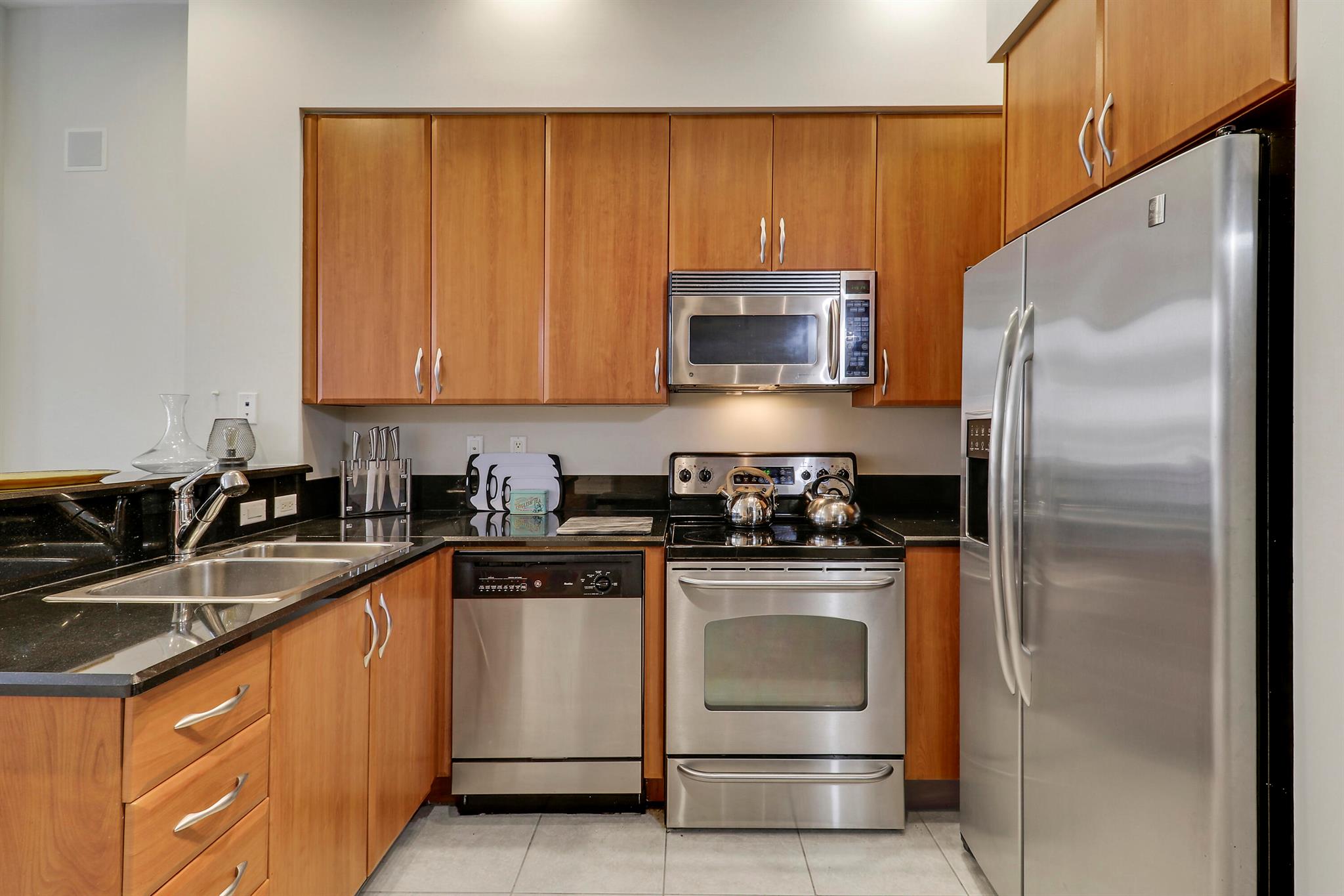 Experience urban luxury in this beautifully furnished, two-story loft featuring soaring 26-foot ceilings and modern design. The open-concept living space is highlighted by a stylish spiral staircase that adds character and elegance. The primary bathroom boasts spacious marbled finishes, creating a spa-like retreat. The kitchen is equipped with 42'' cabinets, stainless steel appliances, and ample storage for all your culinary needs.Enjoy the convenience of an assigned lower-level parking space and a spacious storage locker, making organization effortless. Don't miss the opportunity to make this stunning loft your new home!