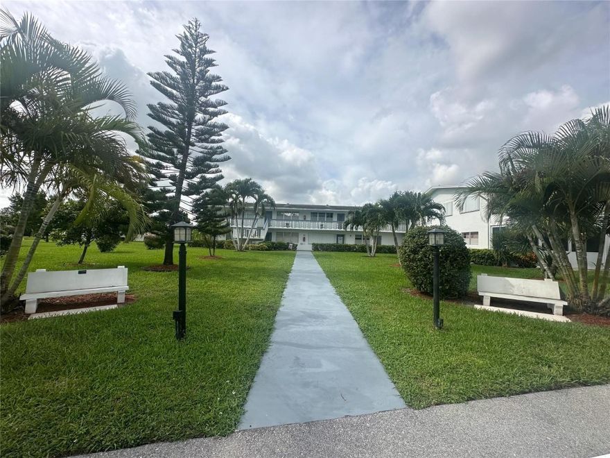 GREAT LOCATION! This 1 bedrm, 1.5 bath condo is in the center of the community. no road noise, close to pool & on the 1ST FLOOR with pkg. rt. in front! Furnished & ready to move rt in! Features include REMODELED KIT w/ white shaker cabs, smooth ceiling & freshly painted, primary bathroom freshly painted. new vanity & lighting, 2 W/W A/C units, sliding glass doors out to the encl patio w/ext. storage overlooking a nice garden view. Bldg. has a lg. comm BBQ picnic area for entertaining guests! Come enjoy the active lifestyle in this gated comm w/24 hr. sec, free bus service, pools, tennis, pickleball, a lavish clubhouse w/gym, theater, movies, classes, indoor/outdoor pools, cafe, & more! Close to shopping, Deerfield Beach, restaurants & highways! YOU WILL LOVE LIVING HERE! Assoc. Claims 55+