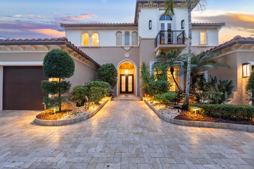 Experience elevated South Florida living in this fully remodeled 6-bedroom, 6.5-bath lakefront estate in the prestigious double-gated subdivision "The Colony" at Heron Bay in Parkland. With coveted west-facing exposure, enjoy breathtaking sunset views. This home shows like a model, featuring soaring high ceilings and a seamless open layout. The first-floor primary suite offers dual bathrooms, double vanities, and spacious walk-in closets. The chef's kitchen includes upgraded appliances, including Sub-Zero refrigerator, wine cooler, and a gas range. Step outside to a resort-style backyard with a remodeled salt water heated pool and spa, summer kitchen, and lush tropical landscaping including a stunning canary palm. Complete with generator, accordion shutters, and low HOA fees.