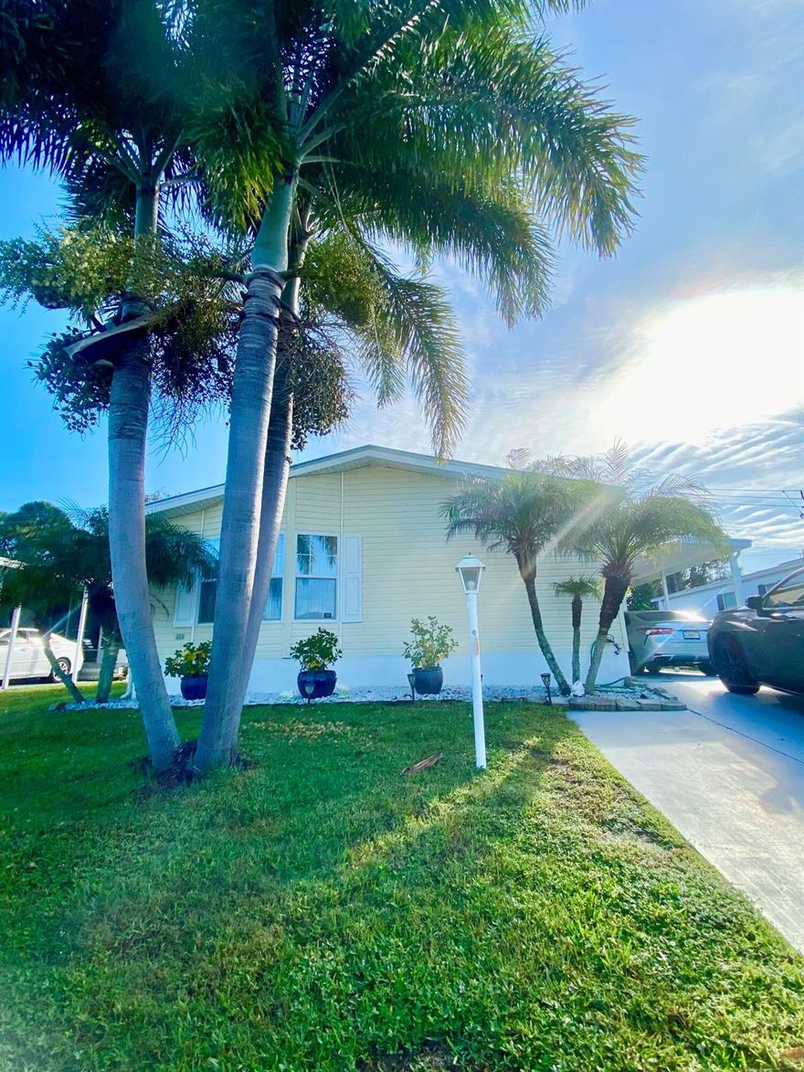 Come see this immaculate, bright 3/2 manufactured home in the beautiful 55+ neighborhood of Tropical Isles.  With tile throughout, a lovely screened patio, and backing up to quiet woods with a large mango tree out back, it's one of the best lots in the community!  The living room has a cozy electric fire place, and an open white kitchen perfect for entertaining family & friends.  The master bedroom is extremely spacious, along with the large master bathroom and walk-in closet.  This home has two matching guest rooms perfect for company or office space.  Come check this out, it's perfect for you!